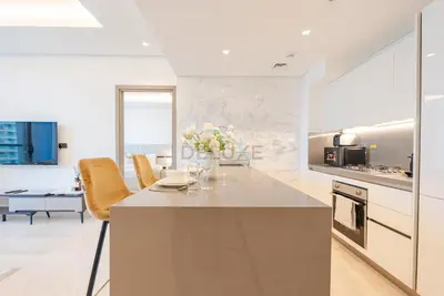 a kitchen with a large island with a counter top at Burj Khalifa Views, Walking Distance to Dubai Mall and Downtown Boulevard - The Sterling West House, Business Bay by Deluxe Holiday Homes in Dubai