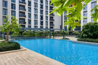 a swimming pool in front of a building at Luxury Modern Home with Direct Park Access in Dubai