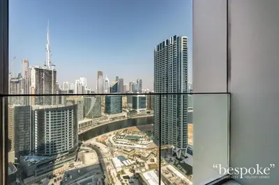 a view of a city from the top of a skyscraper at Bespoke Holiday Homes - Elegant 2BR Waterfront Stay with Canal View in Dubai