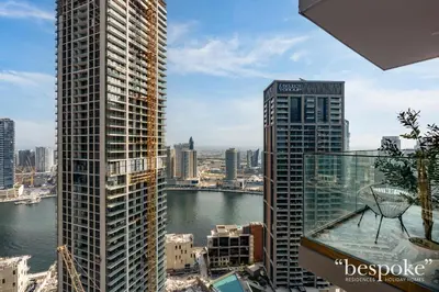 a view of a city with tall buildings and a river at Bespoke Holiday Homes - Elegant 2BR Waterfront Stay with Canal View in Dubai