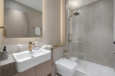 a bathroom with a sink and a toilet and a shower at Stylish Family Retreat That Sleeps 6 In The Heart of JVC in Dubai