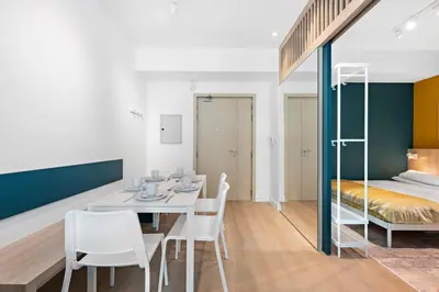 a room with a table and chairs and a bed at Cozy Apartment in Central Dubai Marina near Beach in Dubai