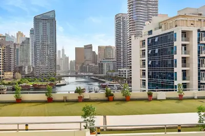 a bench on a balcony with a view of a city at Cozy Apartment in Central Dubai Marina near Beach in Dubai