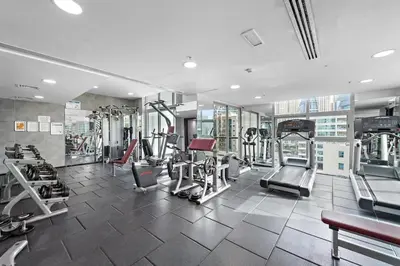 a gym with treadmills and machines in a building at Cozy Apartment in Central Dubai Marina near Beach in Dubai
