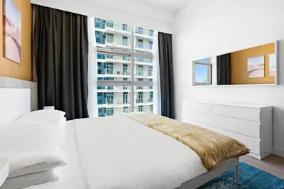 a bedroom with a white bed and a large window at Cozy Apartment in Central Dubai Marina near Beach in Dubai