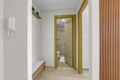 a hallway of a bathroom with a toilet and a mirror at Lush 1BR Apt at Bloom tower in JVC in Dubai