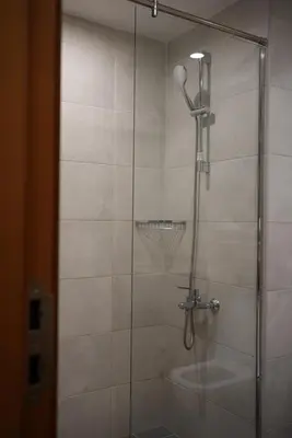 a shower with a glass door with a sink at Marjan Escape Studio in Dubai