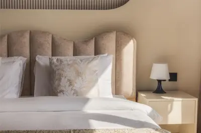 a bedroom with a white bed with a large headboard at Fountain & Opera Views 1 Bedroom Apartment with Balcony in Dubai