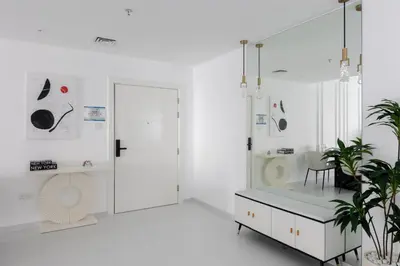 a white bathroom with a shower and a table at Spacious 2BR in Sulafa Tower - Dubai Marina in Dubai