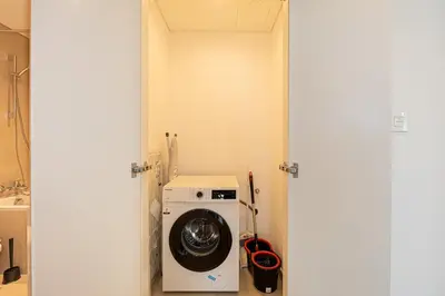 a washer and dryer in a small room at Brand New 1BR, Downtown View, 5 Min Dubai Mall in Dubai