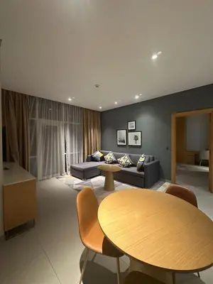 a living room with a table and a couch at Novotel Residence in Dubai