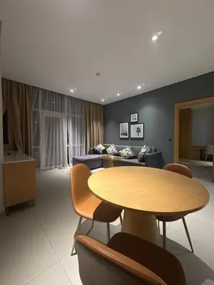 a living room with a table and a couch at Novotel Residence in Dubai