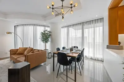 a living room with a table and a couch at 2BR at Opera Grand, Fountain and Burj Khalifa Views in Dubai
