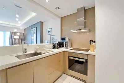 a kitchen with a sink and a counter top at High-Rise Living - Paramount Tower - 1 bedroom in Dubai