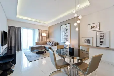 a living room with a table and a couch at High-Rise Living - Paramount Tower - 1 bedroom in Dubai