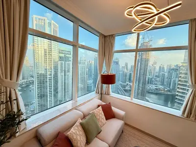 a living room with a couch in front of a large window at Peachy Mint - Luxury 1 BHK - Marina & Sea View in Dubai