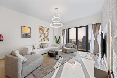 a living room with a couch and a table at Elegant High-Rise Escape with sea view by SoleaStay in Dubai