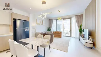 a kitchen and living room with a table and chairs at Stylish2BR Apartment Iconic The Grand LH in Dubai