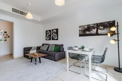 a living room with a couch and a table at The Springs 8 - 2 Bedroom with Maids Room Villa - Allsopp & Allsopp in Dubai