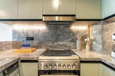 a kitchen with a stove and a counter top at PVH - Modern 1BR with Golf Course View - Golf Gate in Dubai