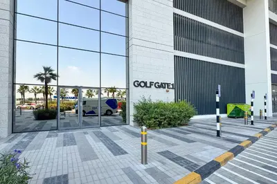 a view of a building with a car dealership at PVH - Modern 1BR with Golf Course View - Golf Gate in Dubai