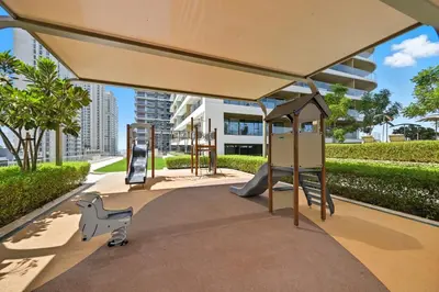 a playground with a slide and a play structure at Cozy 1BD Apartment in Grand Bleu, Emaar Beachfront in Dubai