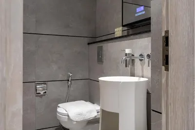 a bathroom with a sink and a toilet at Maison Privee - Serene Studio Escape with Balcony in JVC in Dubai