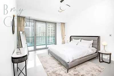 a white bedroom with a bed and a large window at Stunning 2BR Holiday Home JBR Views Dubai Marina in Dubai
