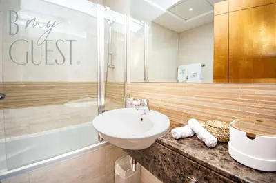 a bathroom with a sink and a toilet and a tub at Stunning 2BR Holiday Home JBR Views Dubai Marina in Dubai