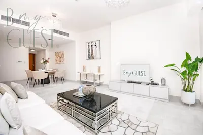 a living room with a white couch and a table at Stunning 2BR Holiday Home JBR Views Dubai Marina in Dubai