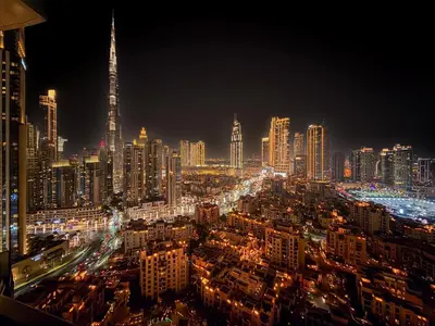 a view of a city at night with lights at GuestReady - 2BR City View | Canal | High Floor in Dubai