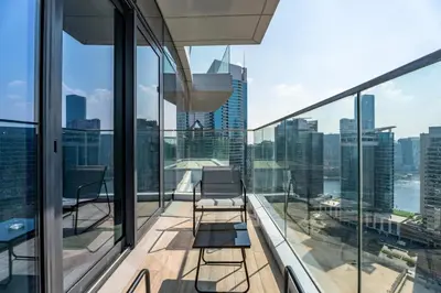 a balcony with chairs and a view of the city at GuestReady - 2BR City View | Canal | High Floor in Dubai