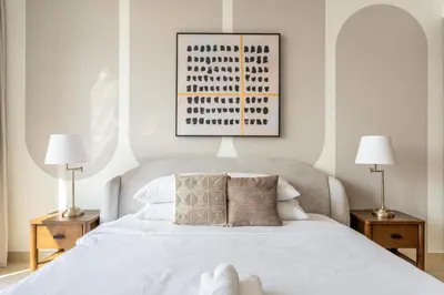 a bedroom with a white bed with two lamps at GuestReady - 2BR City View | Canal | High Floor in Dubai