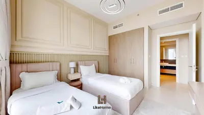 a room with two beds and a table in it at Grand Apartment -3 Bedrooms in Dubai