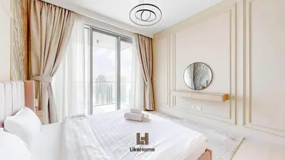 a white bedroom with a bed and a window at Grand Apartment -3 Bedrooms in Dubai