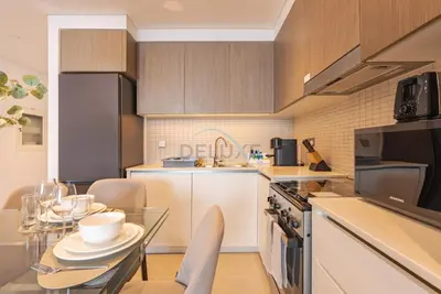 a kitchen with a table and chairs and a counter top at Apartment with Stunning Canal Views, Just Minutes from Dubai Mall and Burj Khalifa - 17 Icon Bay, Dubai Creek Harbour by Deluxe Holiday Homes in Dubai