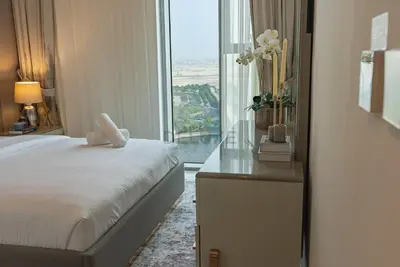 a hotel room with a bed and a large window at Apartment with Stunning Canal Views, Just Minutes from Dubai Mall and Burj Khalifa - 17 Icon Bay, Dubai Creek Harbour by Deluxe Holiday Homes in Dubai