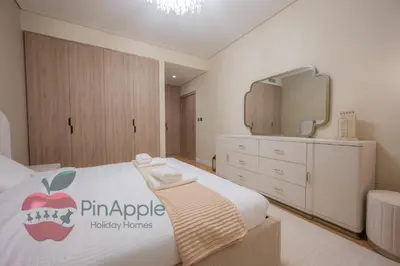 a bedroom with a bed with an apple sign on it at Brand New with Burj Khalifa View in Dubai