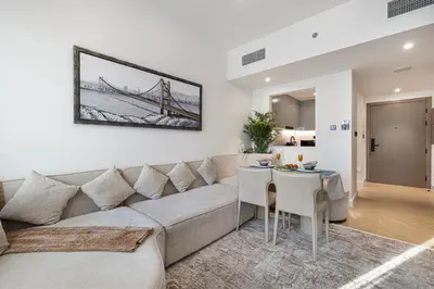 a living room with a couch and a table at Deluxe Binghatti Suites by Hostiva - Burj View in Dubai