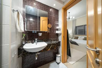 a bathroom with a sink and a mirror at Entire Apartment in Dubai Marina in Dubai