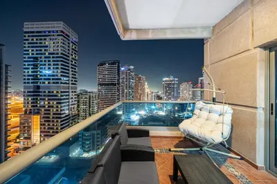 a balcony with a chair and a city skyline at Entire Apartment in Dubai Marina in Dubai