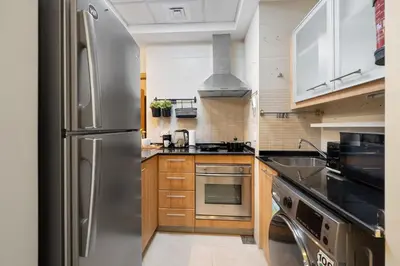 a kitchen with a stainless steel refrigerator at Entire Apartment in Dubai Marina in Dubai