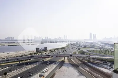 a view of a highway with a city in the background at Bloomfieilds Spacious 1br Azizi Fawad in Dubai