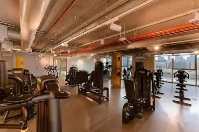 a gym with lots of treadmills and cardio equipment at Modern 1BR Near Dubai Mall in Downtown Views II in Dubai