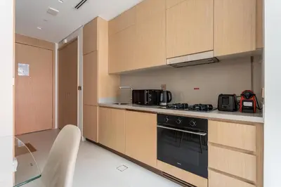 a kitchen with wooden cabinets and a stove at GuestReady - 1BR Near Dubai Mall | Downtown Stay in Dubai