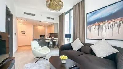 a living room with a couch and a table and a chair at Modern & Cozy 1BR in Business Bay with Pool View - 10AB05 in Dubai