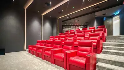 a theatre with red chairs and stairs in a room at Modern & Cozy 1BR in Business Bay with Pool View - 10AB05 in Dubai