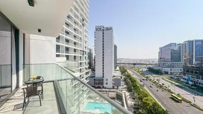 a balcony with a table and a view of a city at Modern & Cozy 1BR in Business Bay with Pool View - 10AB05 in Dubai