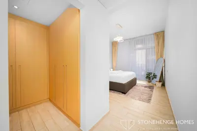 a bedroom with yellow walls and a bed at Cozy 1BR in Belgravia , JVC, Pool View, 20 Min from Downtown Dubai in Dubai