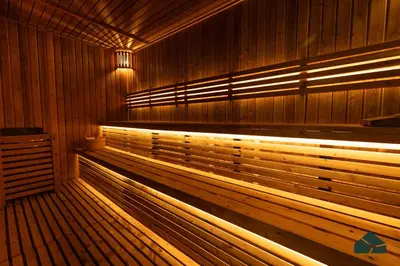 a sauna with wooden benches and lights in it at Peaceful Studio in Opalz by Danube by BMS in Dubai